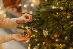 women decorates a pre lit Christmas tree