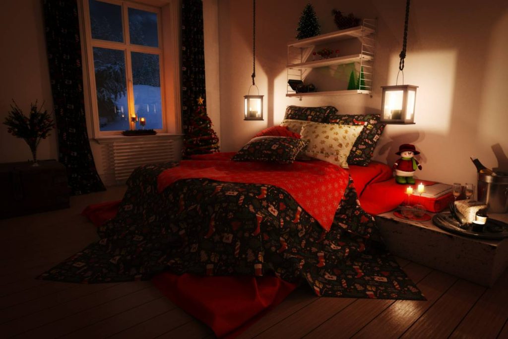 dark bedroom with Christmas sheets and candles