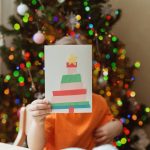 kids holds handmade Christmas card