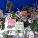 christmas village display with houses and trees