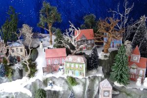 christmas village display with houses and trees