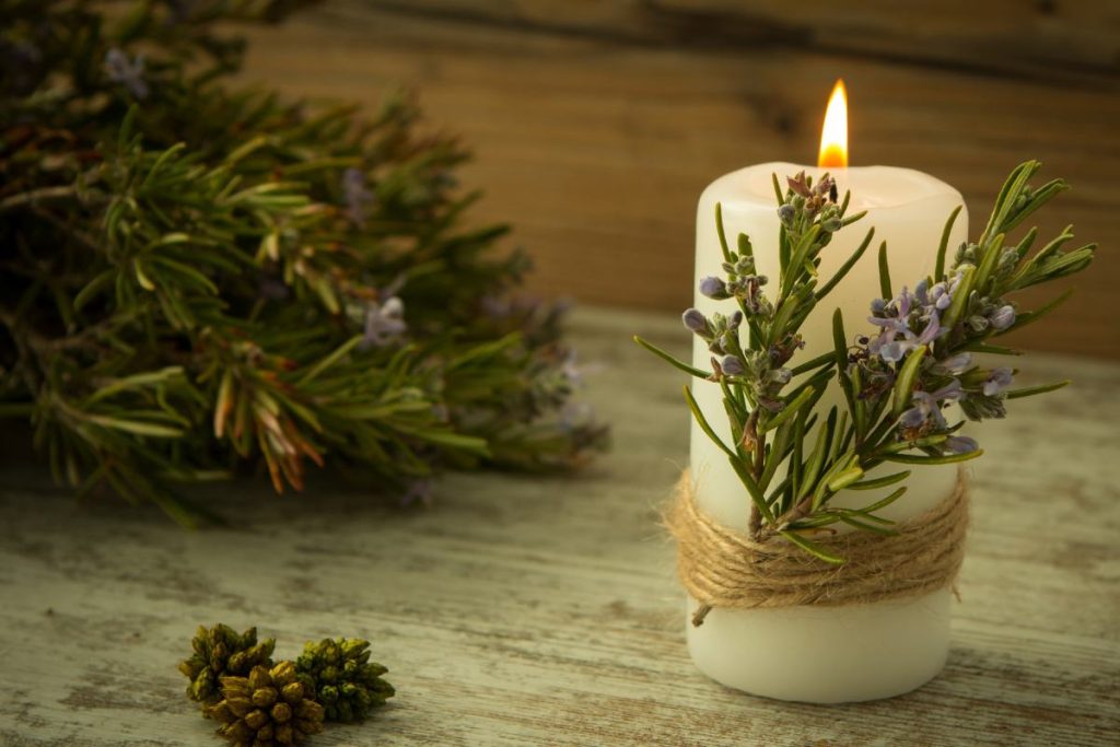 candle decorated with rosemary and scent of Christmas