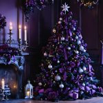 Eye-level photo of a black Christmas tree decorated with velvet ribbons, silver ornaments, burgundy roses, and black feathers beside silver candelabras and a lantern, lit by warm candles and purple fairy lights in a dark-wood Victorian parlor with a frosted window.