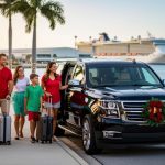 Family of four with suitcases boarding a black shuttle SUV at a palm-lined curb decorated with holiday lights, with a cruise ship visible across the water at Port Canaveral during golden hour.